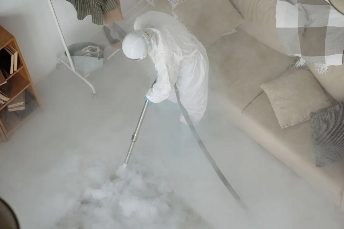 Biohazard cleanup technician in protective equipment, Bastrop, TX